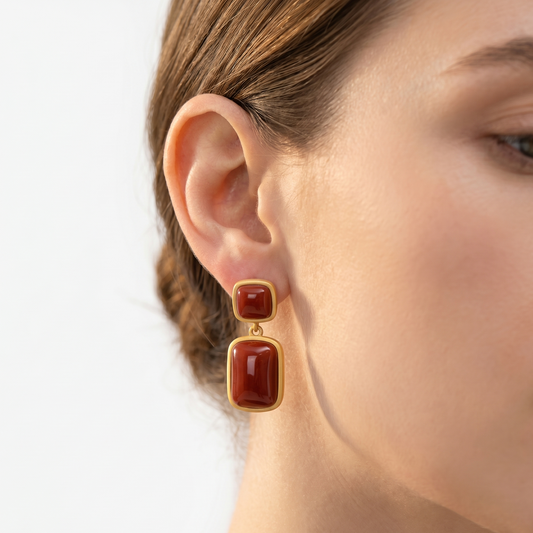 Jade Sapphire earrings with gold-tone frames and red rectangular stones, two-stone drop design.